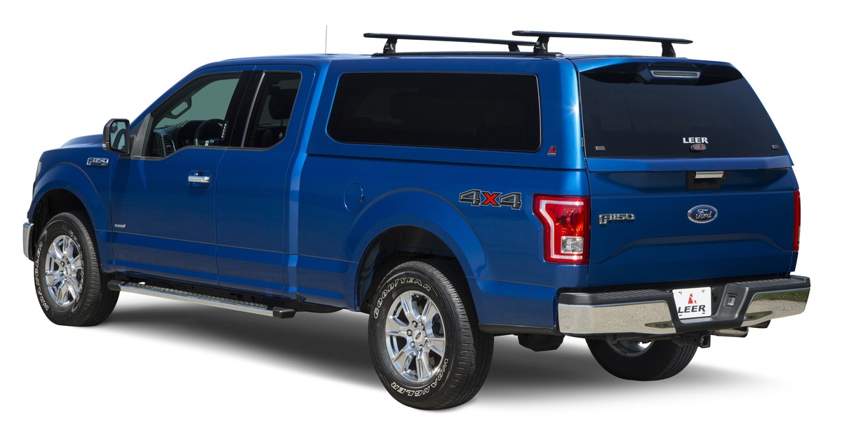 blue-truck-with-camper-shell-and-thule-rack